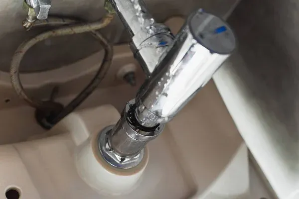 depositphotos_243175102-stock-photo-leaking-steel-pipes-sink-water